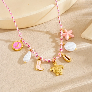 Detail of pink woven necklace featuring gold turtle, shell, and starfish charms