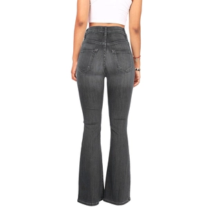 Detail view of high waisted grey flare jeans back pockets and denim texture on white background