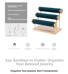 Detail view of a 3-tier gold metal bracelet stand with a solid wooden base and velvet bars