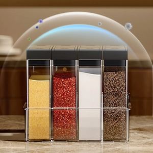 Four-compartment clear seasoning box set with black lids and tray for kitchen spices