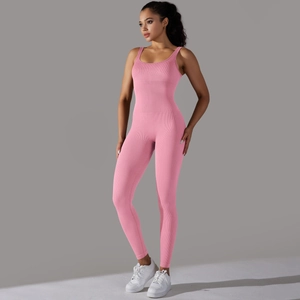 Detail showing the seamless ribbed texture of pink yoga bodysuit with flat neckline
