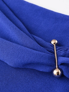 Detail of royal blue ribbed knit fabric featuring a luxurious gold metal bar accent