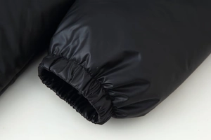 Close-up of elastic windproof cuffs on a black winter hooded parka for women