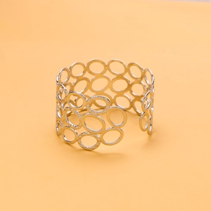 Macro shot of silver multi-layered open bangle with intricate hollow geometric design
