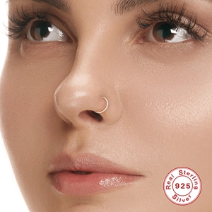 Detailed view of S925 sterling silver hoop ring on nose wing with certified silver seal