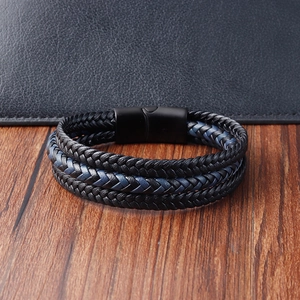 Men's multilayer braided leather bracelet with magnetic buckle on a textured background