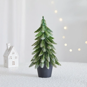 Miniature flocked Christmas tree with snow effect in a black pot for table decor