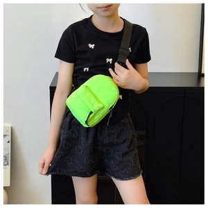 Close-up of neon green nylon mini crossbody bag worn on chest for sports and fitness
