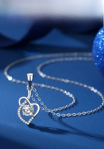 Macro detail of s925 silver heart pendant with brilliant moissanite stone and pave accents