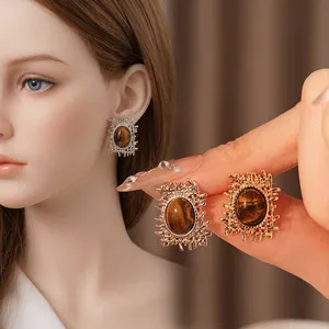 Vintage oval tiger eye stone earrings with irregular woven metal frames in gold and silver