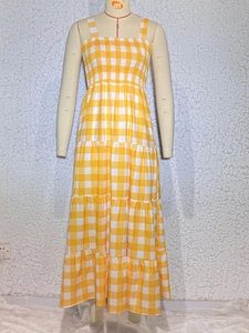 Detailed close-up of smocking bodice and yellow gingham tiers on bohemian maxi dress