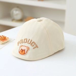 Detailed embroidery of PRODUCT text and bear patch on beige cotton beret for kids