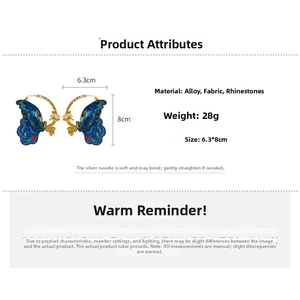 Detail view of blue butterfly earrings showing dimensions of 6.3cm width and 8cm height