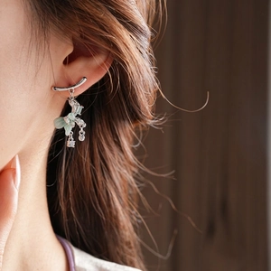 Silver bow tassel earrings with green jade-like accents and sparkling cubic zirconia