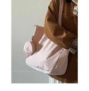 Pink nylon tote bag detail with matching round coin purse and comfortable shoulder strap