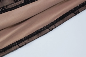Détail de la dentelle noire et doublure marron sur cette robe moulante sexy ajustée
