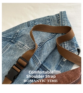 Detailed macro view of brown corduroy chest bag with adjustable woven strap and plastic buckle