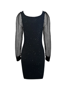 Detail showing elegant black sequin dress with sheer polka dot mesh puff sleeves