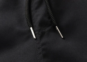 Macro shot of the drawstring details on these black loose athletic shorts for men