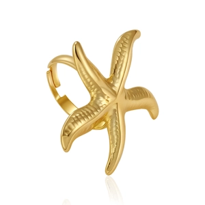 Macro detail of golden starfish ring featuring adjustable open band and polished texture