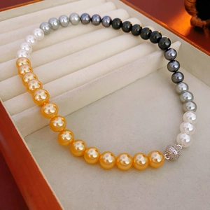 Macro detail of multi-colored gradient pearls with a sparkling rhinestone magnetic clasp