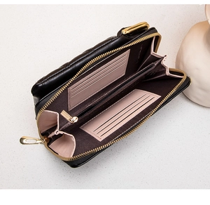 Internal view of quilted leather phone bag showing pink card slots and gold zipper