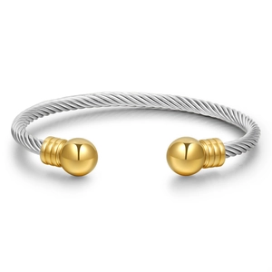 Twisted stainless steel cable wire bracelet with gold ball ends on white background