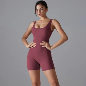 Close-up of dusty rose yoga romper featuring a deep U-neck and ribbed athletic fabric