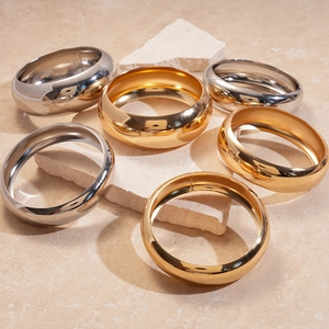 Minimalist chunky round metallic bangles in gold and silver finish on stone base