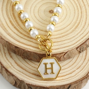 Elegant 18K gold plated pearl necklace featuring a hexagonal marble letter H pendant