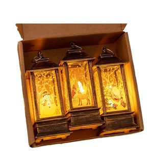 Three-piece Christmas LED lantern set with bronze finish featuring Santa, snowman, and elk