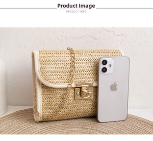 Detailed view of woven straw bag with metal twist lock and chain strap showing size scale