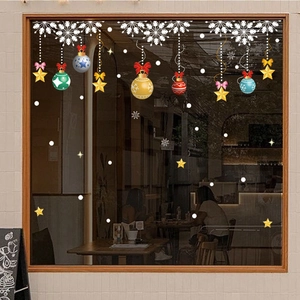 Detailed Christmas window stickers featuring snowflakes and baubles on a cafe glass pane