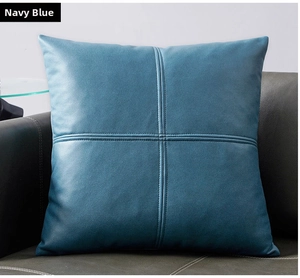 Detail of navy blue high-end fabric cushion cover with cross-stitch design on sofa