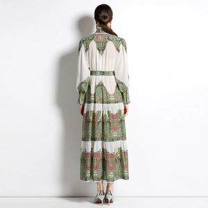 Vintage floral maxi dress with long sleeves and pleated skirt shown from the back view