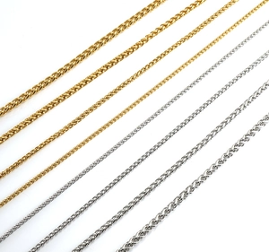 Detail view of 18K gold and silver wheat link chains in various sizes for men