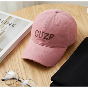Detail of pink vintage baseball cap with GUZF embroidery and distressed washed cotton fabric