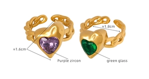 Detail of gold-plated chain rings with purple zircon and green glass heart gemstones