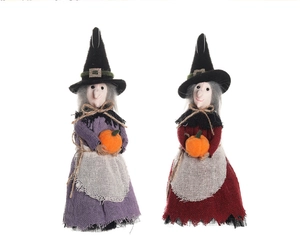 Detail of hanging witch dolls with purple and red skirts holding orange pumpkins