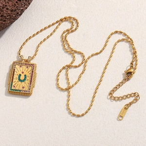 Detailed macro view of 18K gold plated fortune necklace with green zircon horseshoe