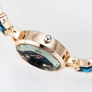 Elegant gold starfish watch for women featuring blue faceted gemstone bracelet links