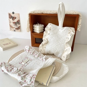 Detail of floral ruffle quilted cotton handbags set with button closure and top handle