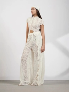 Women's white lace two-piece set featuring crop top and high-waist wide-leg pants