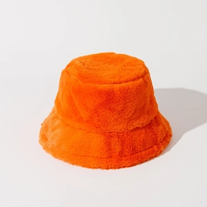 Detail showing the plush faux fur texture of the bright orange winter bucket hat