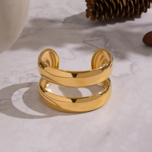 Minimalist double-layer 18K gold plated stainless steel open bangle on marble surface