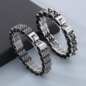 Close-up of woven black leather bracelet with dragon scales and metal lock for men