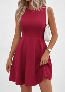 Detail of a deep red sleeveless A-line dress with slim waist and pleated flared skirt
