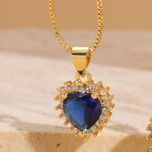Macro shot of a heart-shaped blue zircon pendant with 14K gold-plated box chain
