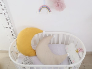 Quilted cotton moon and star pillows with pompoms for nursery decoration and infant comfort