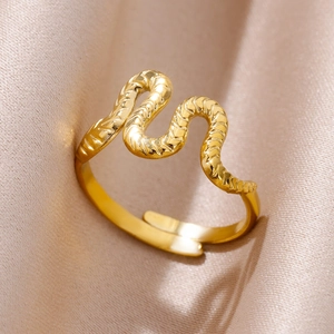 Macro shot of 18k gold plated snake ring with detailed scale texture on silk fabric